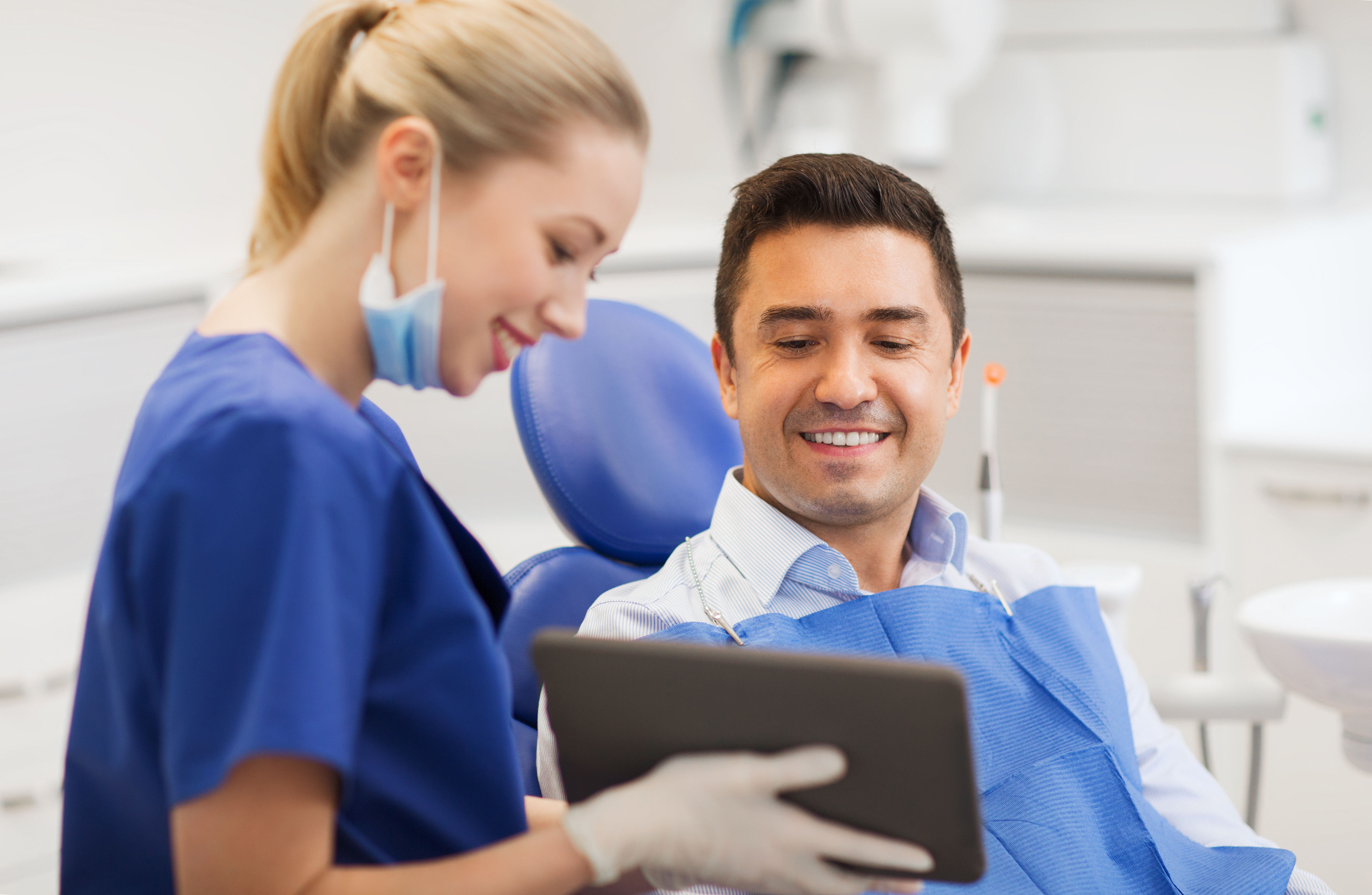 younger couple hugging inside | dentist dedham ma